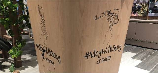 #VlogWithSony die-cut sticker on a wooden display — Die Cut Stickers by Garrison Productions, Singapore
