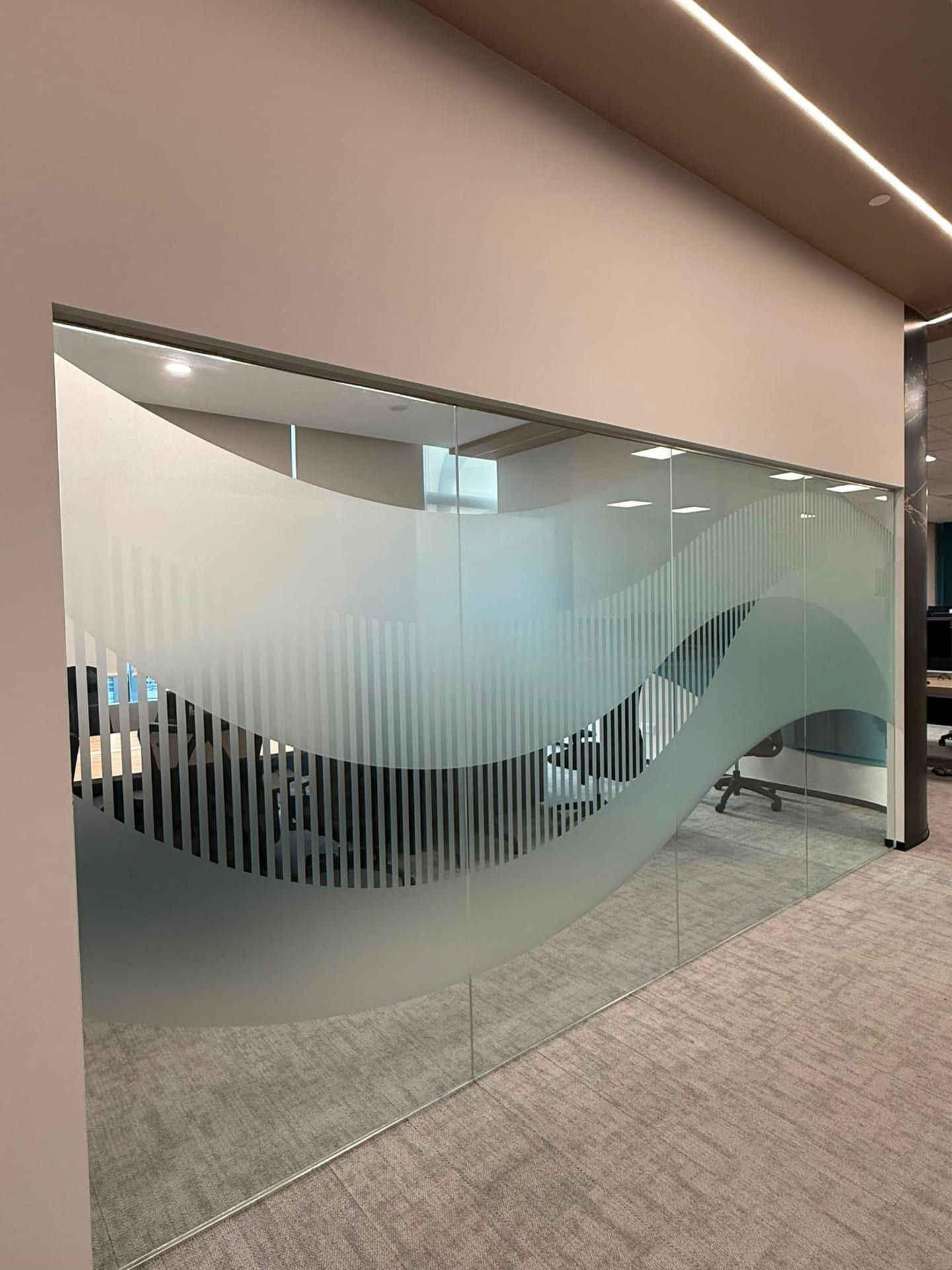 Wave-pattern frosted film on a curved glass wall — Frosted Film by Garrison Productions, Singapore