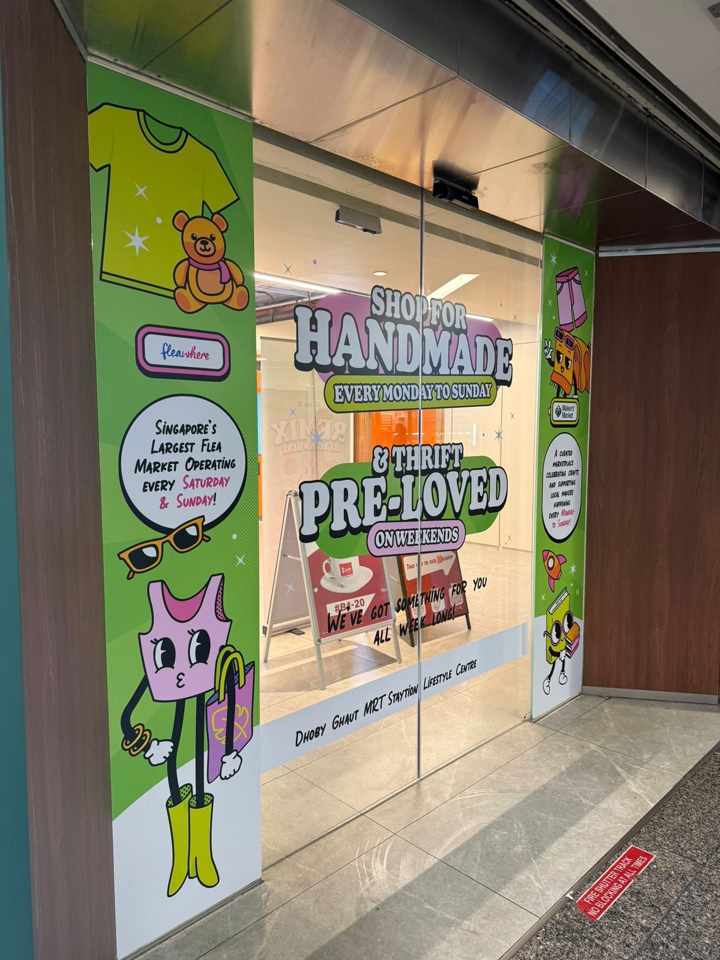 "Handmade, pre-loved" glass stickers on a shop entrance — Glass Stickers by Garrison Productions, Singapore