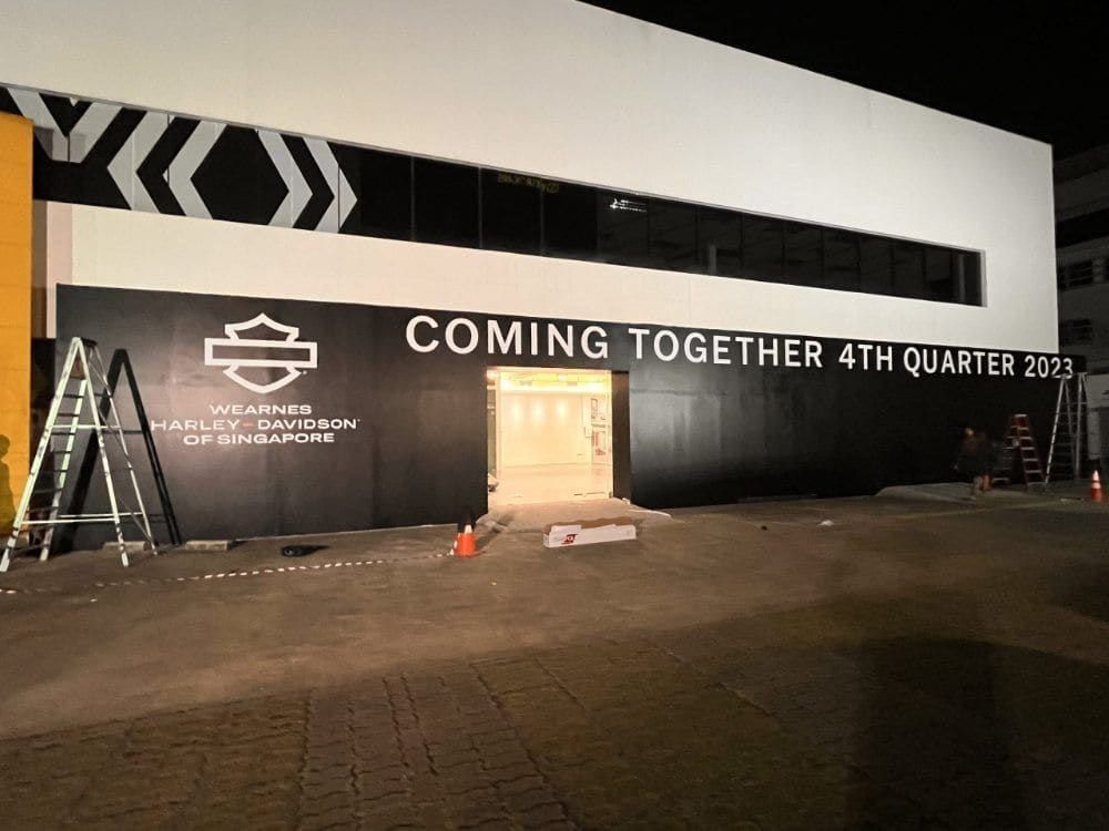 Harley-Davidson hoarding being installed at night — Hoarding Sticker Printing by Garrison Productions, Singapore