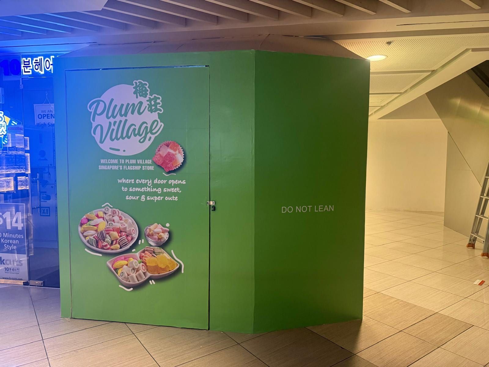 Plum Village green kiosk hoarding — Hoarding Sticker Printing by Garrison Productions, Singapore