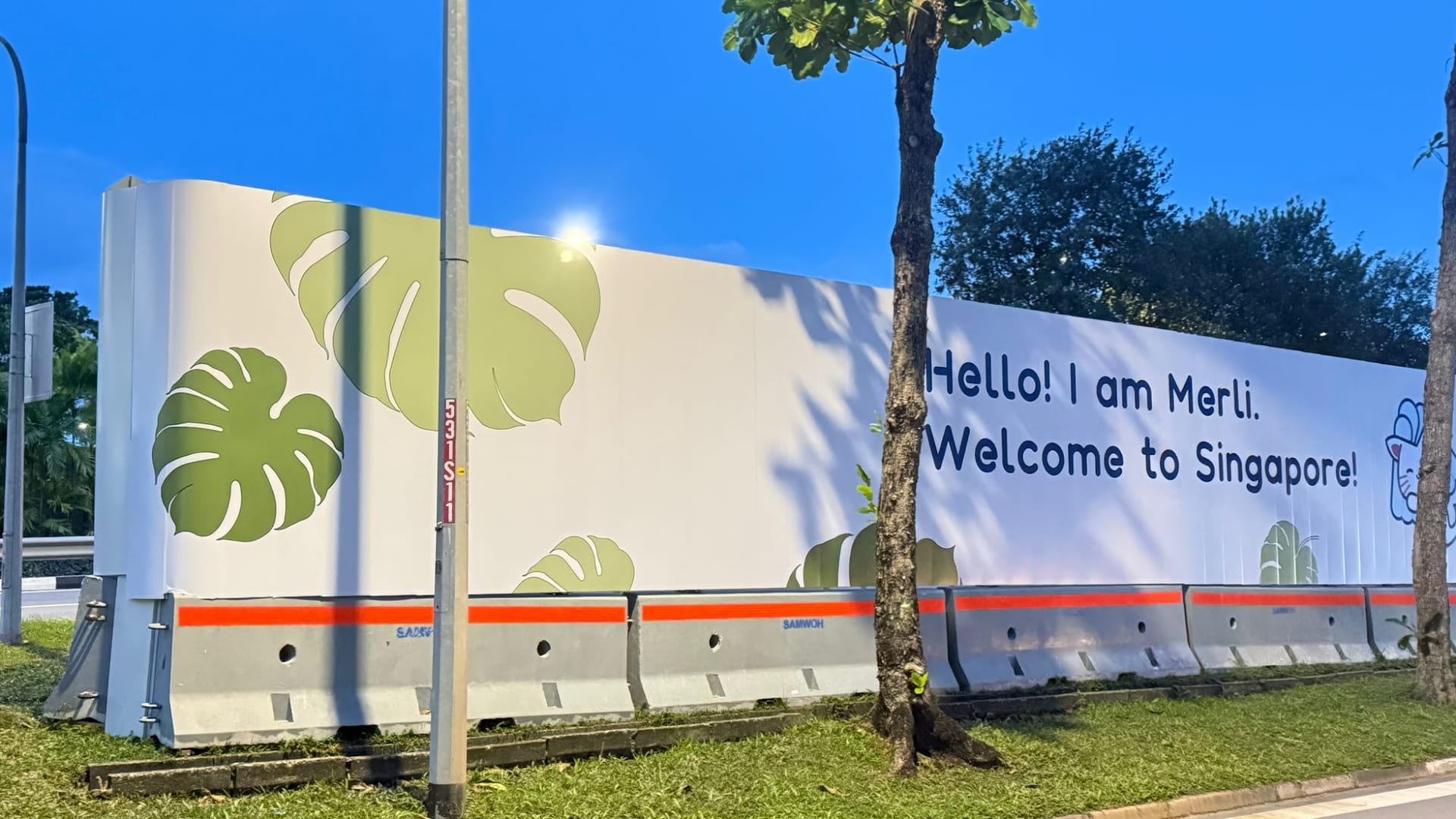 "Hello! I am Merli. Welcome to Singapore" LTA hoarding — Hoarding Sticker Printing by Garrison Productions, Singapore