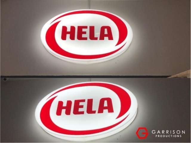 HELA oval lightbox signs, lit and unlit — Lightbox Signage by Garrison Productions, Singapore