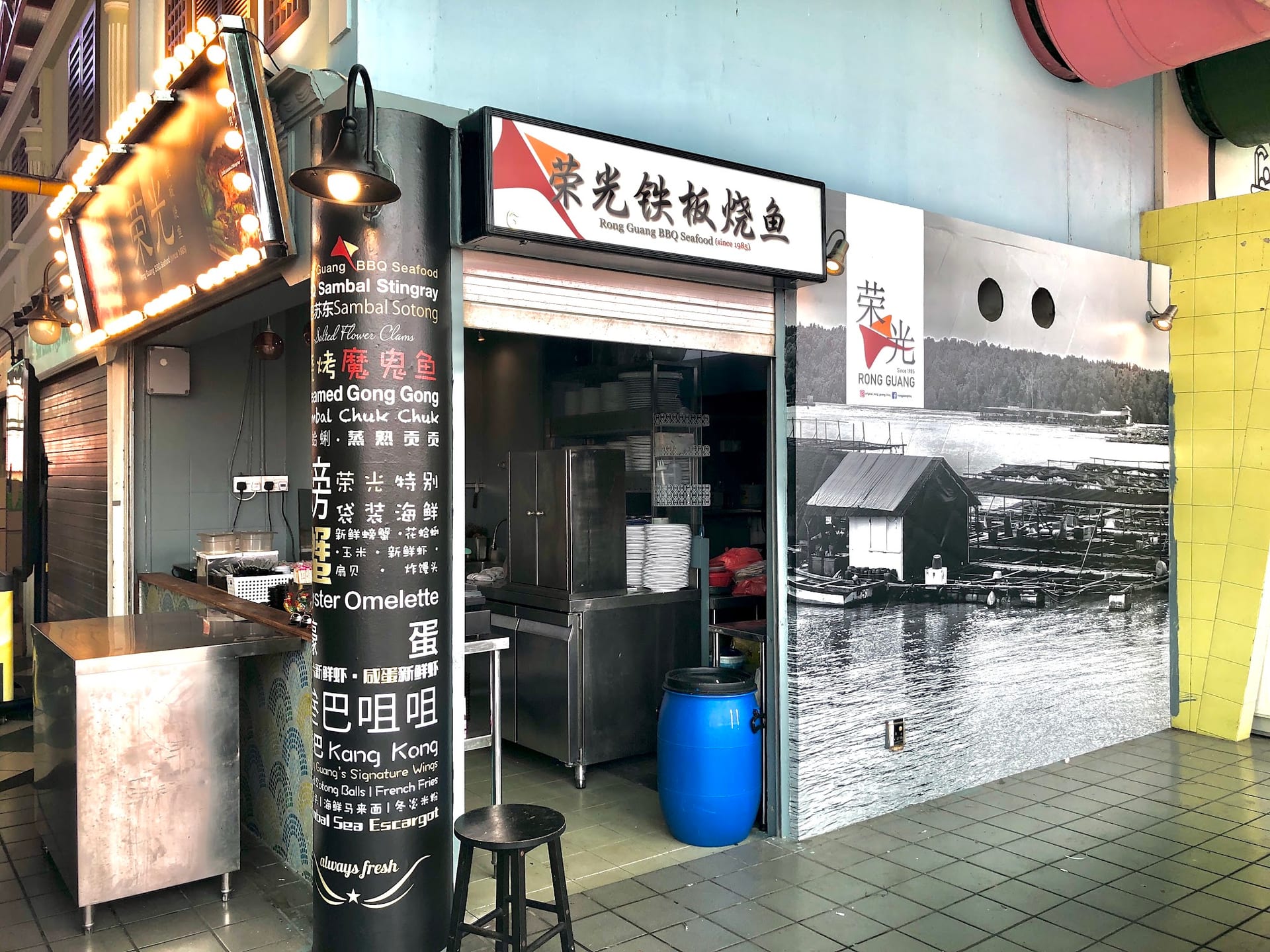 Black-and-white heritage photo mural at a food stall — Wall Mural by Garrison Productions, Singapore